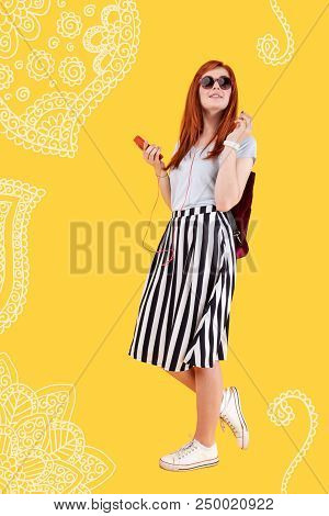 Pleasant Walk. Cute Relaxed Young Girl Feeling Good And Smiling While Listening To Music In Her Earp