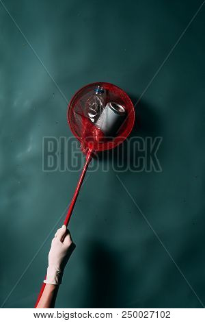 Cropped Shot Of Person In Latex Glove With Butterfly Net Cleaning Water From Rubbish