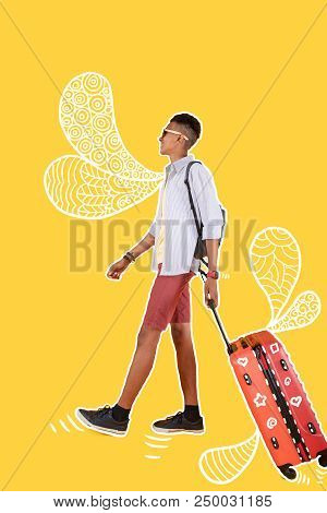 Walking With Suitcase. Positive Relaxed Boy Carrying A Suitcase And Feeling Good While Being On The 