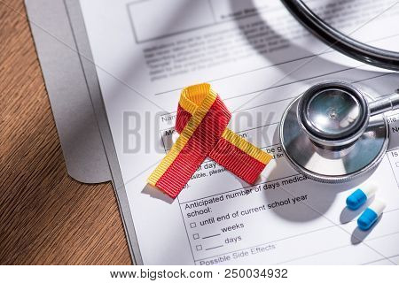 Selective Focus Of Ribbon, Stethoscope, Pills And Medical Questionary, World Hepatitis Day Concept
