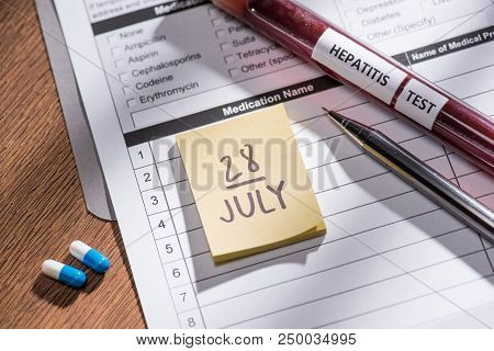 Selective Focus Of Stick It 28th July Date, Medical Questionary, Pills And Test Flask With Lettering