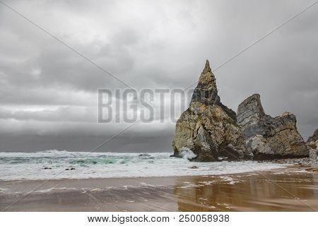 Sharp Rocks, Sand And Dark Stormy Clouds