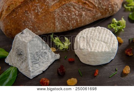 French Goats Cheeses And Bread On Background