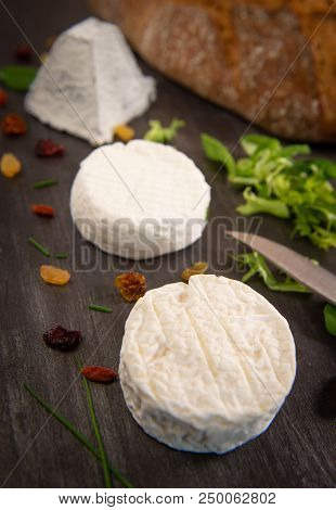 French Goats Cheeses And Bread On Background