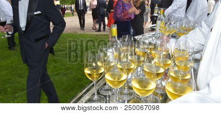 Professional Waiter In Uniform Is Serving Wine
