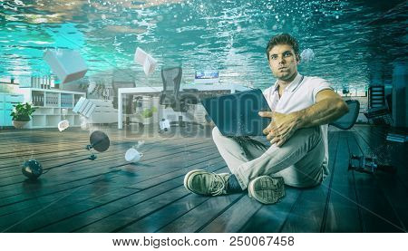man work sit on the floor with his laptop in flooded office