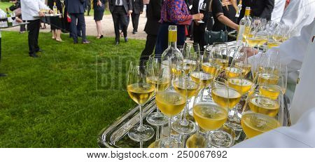 Professional Waiter In Uniform Is Serving Wine