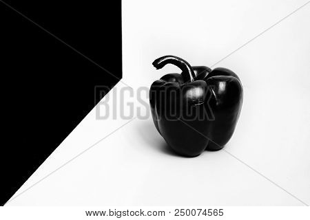 Black And Glossy Bell Pepper On A White Background