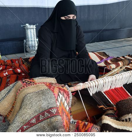 Moscow, Russia - July 14, 2018: A Young Arabian Woman From Qatar Makes A Traditional Sadu Weaving.