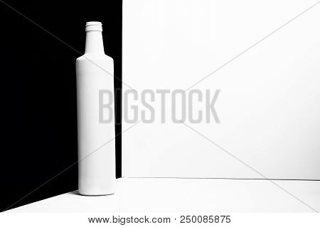 White Bottle On The White And Black Backgroun