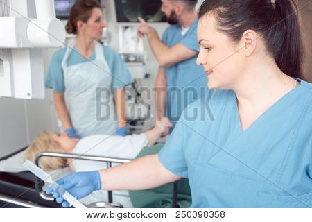 Team of nurses and doctors preparing for endoscopy examination greeting patient
