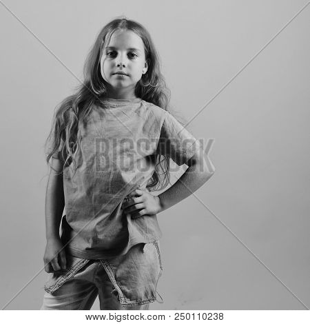 Kid Poses As Bgirl In Cool Style. Girl With Happy Face On Blue Background, Copy Space. Child Looks L