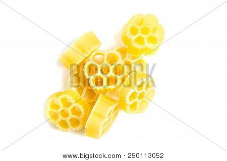 Raw Uncooked Rotelle Dry Italian Pasta. Ruote, Wagon Wheel Shaped. Heap, Isolated On White Backgroun