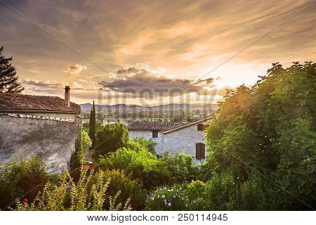 Tiled Roofs Of Houses And Sky With Clouds On The Background Of Mountains. Beautiful Scenic View Of B