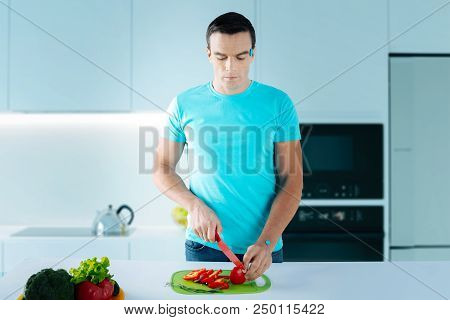 Careful Robot. Modern Futuristic Humanoid Robot Looking Concentrated While Standing In A White Lacon