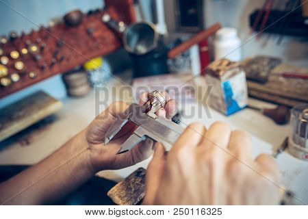 Different Goldsmiths Tools On The Jewelry Workplace. Jeweler At Work In Jewelry. Desktop For Craft J