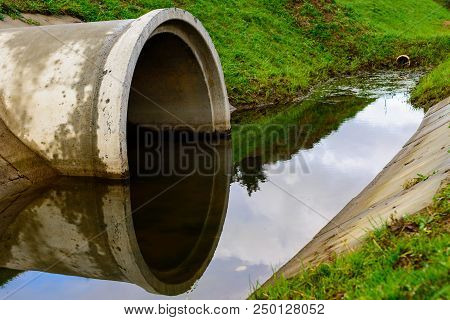 Concrete Culvert Pipe Hole System Draining Sewage Water. Environmental Disaster