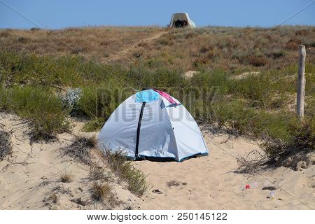 Tourist Tent On The Sand. Parking Of Tourists On The Sandy Beach.