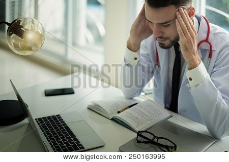 Doctors Are Making Serious Faces And Stressed About Work. The Doctor Is Feeling A Headache At Work A