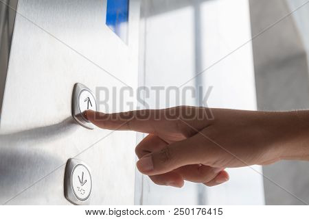 Close Up Waman Hand Press A Up Button Of Elevator Inside The Building For Upper High Level Floor.