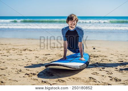 Young Man Surfer Training Before Go To Lineup On A Sand Beach. Learning To Surf. Vacation Concept. S