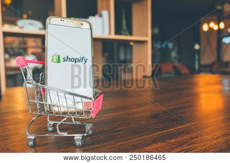 Chiang Mai,thailand - July 7,2018: Mobile Phone Using Shopify App On The Screen In Shopping Cart On 