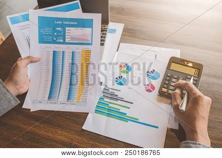 Real Estate Agent Working With Caculator,laptop And Document On Wooden Table In The Office, Loan And