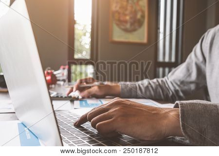 Business Accounting, Businessman Using Computer Laptop With Document And Caculator In Office, Saving