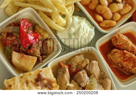 Stewed Vegetables And Meat With French Fries And Cutlets With Beans And Sour Cream Sauce With Cucumb
