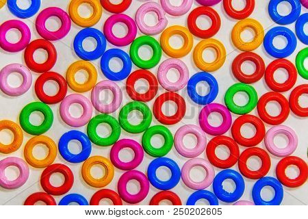 Colored Colorful Wooden Rings In The Background On White