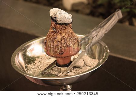 Ajami Tobacco Leaves Burning In A Hookah Head, Vintage Colors.