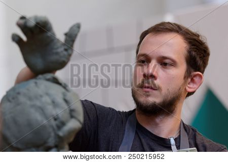 ST. PETERSBURG, RUSSIA - JULY 15, 2018: Sculptor Danila Reshetov participates in artistic battle during the opening of festival Laboratory Of Sculpture in the museum workshop of sculptor M. Anikushin