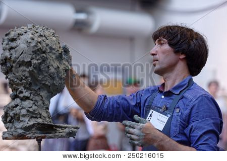 ST. PETERSBURG, RUSSIA - JULY 15, 2018: Sculptor Oleg Shorov participates in artistic battle during the opening of festival Laboratory Of Sculpture in the museum workshop of sculptor Mikhail Anikushin