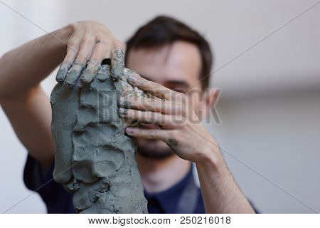 ST. PETERSBURG, RUSSIA - JULY 15, 2018: Sculptor Pyotr Subbotin participates in artistic battle during the opening of festival Laboratory Of Sculpture in the museum workshop of sculptor M. Anikushin