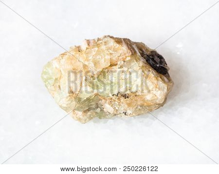 Macro Shooting Of Natural Mineral - Rough Chrysoberyl (green Beryl) Crystal On White Marble From Ura