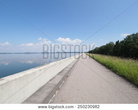 Scenic Walkway With Lamps On Barrage At Countryside Landscapes Of Lake, Field, Forest On European Ar