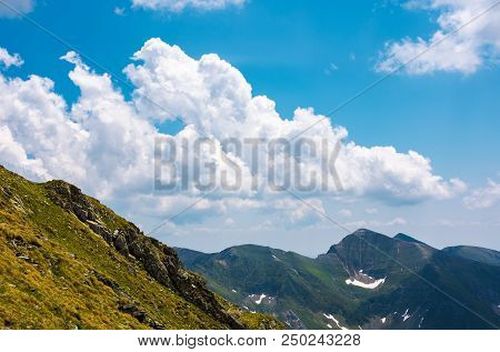 Beautiful Cloudscape Over The Fagaras Mountains. Bright Sunny Day In Romania. Beautiful Nature Backg