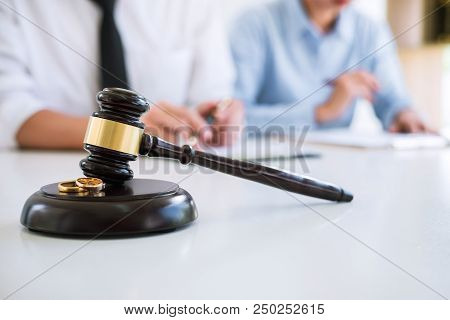 Close Up Of Judge Gavel And Two Golden Marriage Ring, Contract Decree Of Divorce (dissolution Or Can