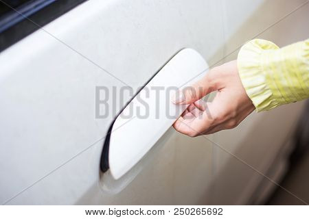 Woman Unlock And Open Door Of White Car And Go To Carcare In Order To Wash Her Car