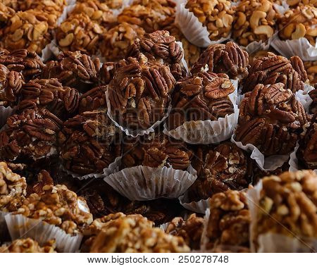 Picture Of Many Tasty Individually Wrapped Chewy Pecan Praline Bites, Ready To Eat. Showing, Shallow