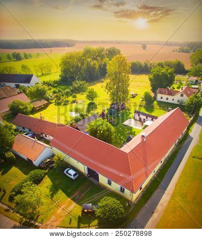 Sunrise over a South Bohemian village Ujezdec. Typical Czech farm houses from 17th century. Agricultural landscape in Central Europe.