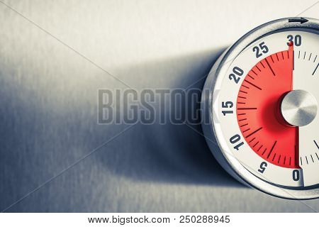 30 Minutes - An Analog Kitchen Timer With Red Mark Placed On A Fridge In Monochrome Colors