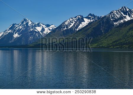 Teton Range With Reflections Of The Peaks In Jackson Lake