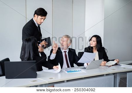 group of successful businessman. Discussion of the business profits of the company in meeting roon o