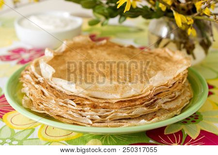 Delicate Fishnet Pancakes With Sour Cream. Selective Focus.