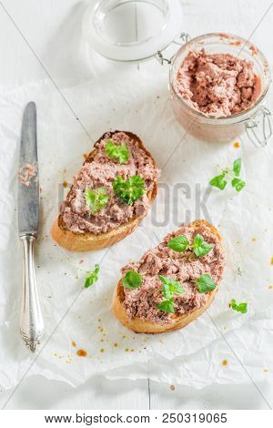 Tasty Bruschetta With Fegatini And Herbs On White Table