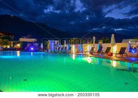 Swimming Pool At A Luxury Resort By Night In Lana