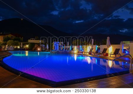 Swimming Pool At A Luxury Resort By Night In Lana