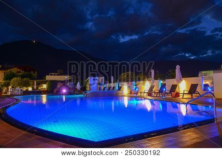 Swimming Pool At A Luxury Resort By Night In Lana