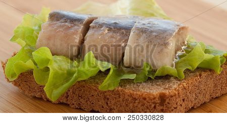 Sandwich Of Rye Bread And Herring With Lettuce